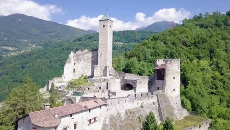 Aerial-panoramic-view-of-Castel-Telvana-in-Borgo-Valsugana,-Trentino,-Italy-with-drone-flying-forward-on-a-very-clear-day