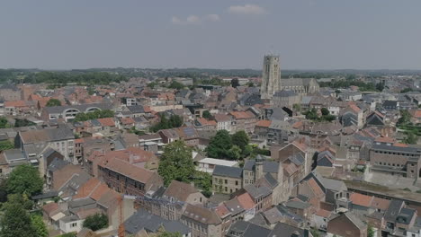 AERIAL:-A-city-with-its-church-dominating-the-view-on-a-beautiful,-summer-day