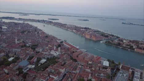 Wide-aerial-shot-of-moving-towards-Giudecca-from-above-at-dusk,-Venice,-Italy