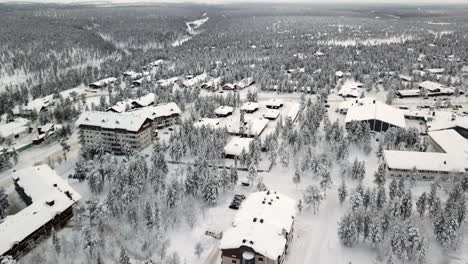 Drone-flying-over-a-hotel-in-Saariselka,-Lapland,-Finland