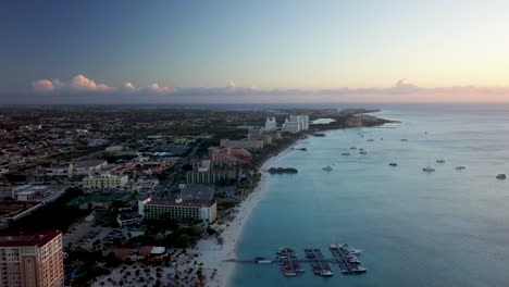 The-coastline-of-Aruba-from-Palm-Beach-with-boats-in-the-Caribbean-Sea-during-sunset