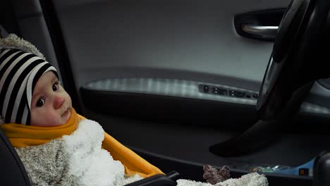 Baby-boy-with-yellow-scarf-sitting-peacefully-in-the-seat-of-the-driver