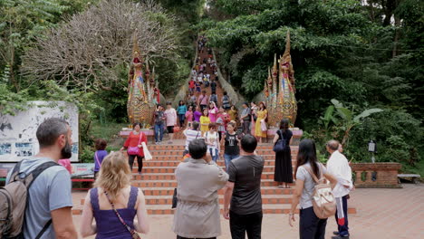 Tourists-taking-pictures-at-the-steps-at-Wat-Phra-That-Doi-Suthep,-Chiang-mai,-Thailand