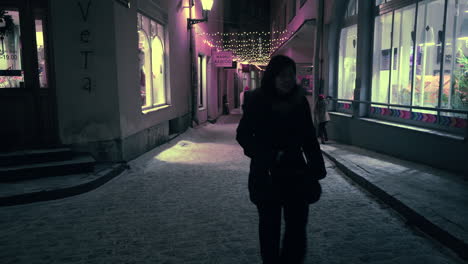 Tilt-up-of-tourists-walking-on-narrow-street-in-Old-Town