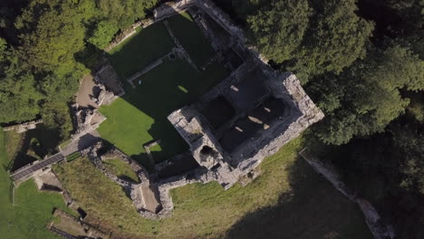 Aerial-view-of-Norham-Castle-ruin-on-a-sunny-day,-Northumberland,-England