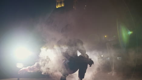 African-American-man-kneeling-in-smoke-and-headlights
