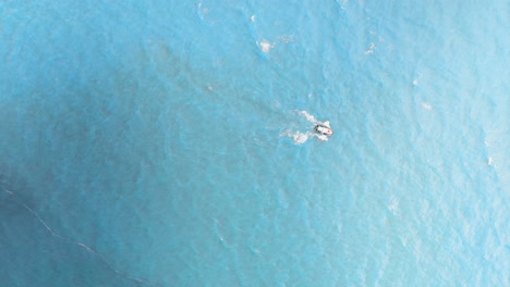 High-top-drone-view-of-a-tradicional-wooden-fisher-boat-on-the-blue-ocean