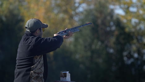 A-man-following-a-target-with-a-rifle-at-a-shooting-range