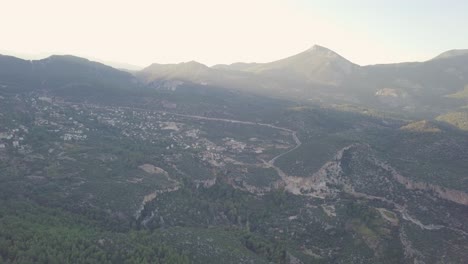 Sunlight-filtering-through-over-the-mountainous-landscape-of-the-small-village-of-Geyikbayiri-in-Antalya-Turkey-as-shown-by-slow-moving-aerial-clip-taken-by-drone
