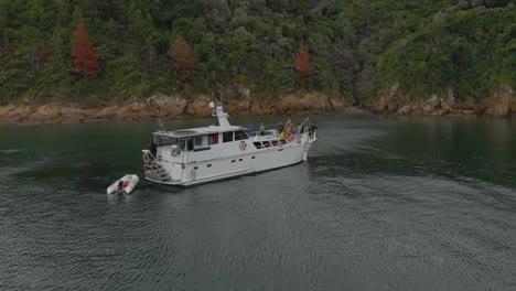 SLOWMO---Group-of-people-on-anchored-cruise-boat-in-bay-in-Marlborough-Sounds,-New-Zealand