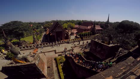 Tourists-walking-on-stairs-to-the-top-of-a-temple-in-Ayutthaya,-Thailand