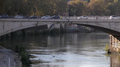 Cars-driving-over-Ponte-Sisto-bridge-above-the-Tiber-river-in-Rome