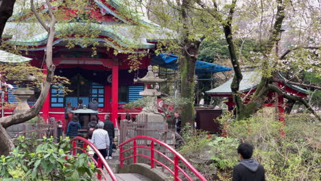 People-cross-a-bridge-and-pray-at-Inokashira-Benzaiten-Shrine