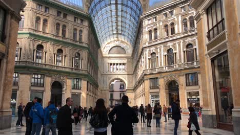 Naples,-Galleriia-Umberto-glass-Italian-landmark-tourism-ceiling-design,-tourist-on-vacation-below-viewing-historic-structure