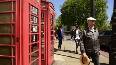 London-streetscape-on-a-sunny,-spring-day,-featuring-the-iconic-British-red-telephone-boxes