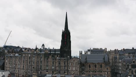 Drone-fly-to-The-Hub-tower,-historic-cultural-building-in-Edinburgh-city,-Scotland,-UK