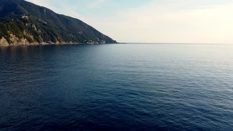Blaues-Ozeanwasser-Mit-Sanften-Wellen-Unter-Dem-Berg-Der-Camogli-küste,-Genova,-Italien
