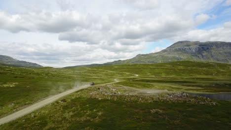 Black-automobile-belching-smoke-along-an-empty-road-in-Norway