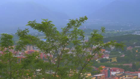 Landscape-Houses-In-The-Mountain-Covered-In-Fog-With-Trees-At-The-Side