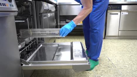 a-medical-instrument-washing-machine-is-loaded-with-instrument-trays