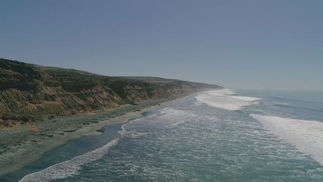 Aerial-Drone-view-of-waves-coming-in-on-a-Beach-in-Ensenada,-Mexico