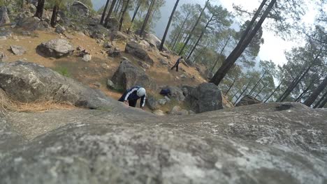 Male-rock-climber-climbing-the-mountain-on-a-sunny-day