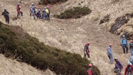 Himalayan-Mountaineers-at-rocky-mountain-Himalayan-mountaineers-rappelling-a-rocky-mountain-of-upper-Himalayas,-Uttarakhand-India