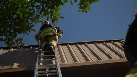 Firefighter-climbing-up-a-ladder-during-an-emergency-response-and-rescue-operation