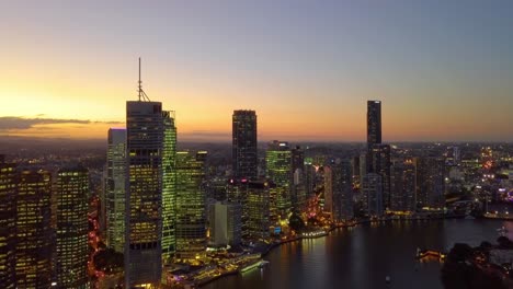 Fast-moving-aerial-view-of-Brisbane-city-CBD-riverside-at-sunset