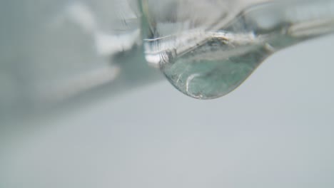 White-transparent-dripping-slowly-from-a-glass-surface