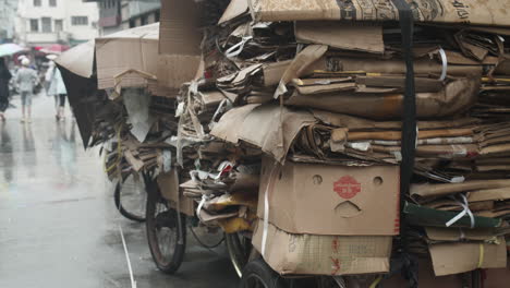 A-parked-rickshaw-heavy-loaded-with-carton-boxes-for-recycling-on-a-rainy-foggy-day,-Shanghai,-China