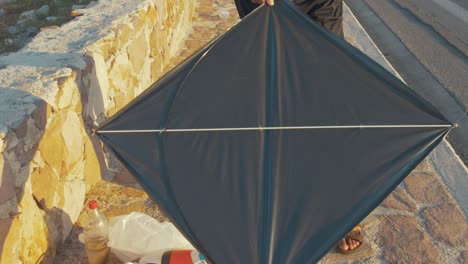 Young-Afghan-refugee-preparing-self-made-kite-by-seaside-Lesbos