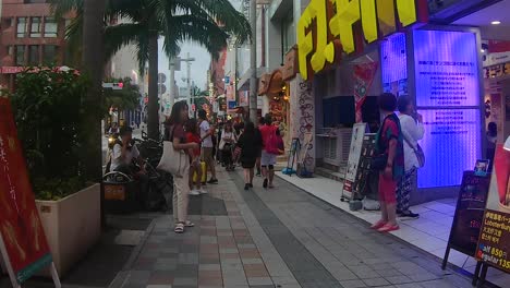 Waist-level-point-of-view-of-a-pedestrian-walking-amongst-shoppers-on-the-sidewalk