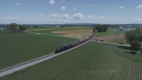 Aerial-View-of-Farmlands-and-Countryside-with-a-Vintage-Steam-Train-Puffing-Along-on-a-Sunny-Summer-Day