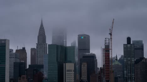 Time-Lapse-of-clouds-over-the-skyscrapers-and-new-buildings-under-construction-at-East-Side-Manhattan,-New-York-City,-USA