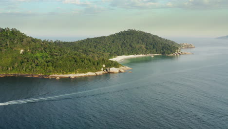 Cinematic-aerial-view-of-a-paradisiac-rainforest-beach,-Campeche-Island,-Florianopolis,-Santa-Catarina,-Brazil