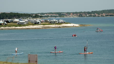 Stand-Up-Paddler,-Windsurfer,-Tretboote-Und-Schlauchboote-Fahren-Auf-Dem-Meer-In-Premantura-Istria-Croatia