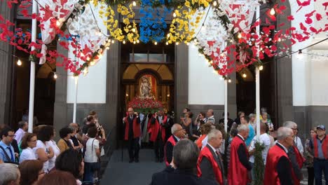 Christian-Religious-Festive-Celebration-procession-in-honor-of-saint-John-The-Baptist,-men-carry-the-statue-and-houndreds-of-people-walk-while-praying