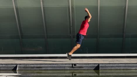 man-training-jumping-outdoors-urban-landscape