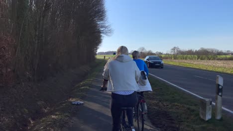 People-Biking-On-Asphalt-Trail-In-A-Rural-Area-On-A-Sunny-Morning