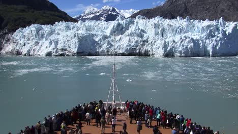 Tourists-on-the-bow-of-a-cruise-ship-in-Glacier-Bay-National-Park-Alaska,-looking-at-the-Margerie-Glacier-and-enjoying-the-landscape