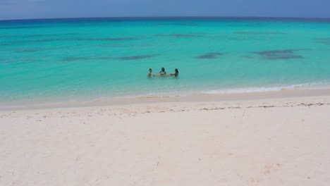 Three-girls-bathing-and-drinking-in-turquoise-sea-waters-at-Eco-del-mar