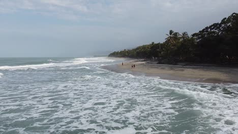 Tourists-have-sunny-Caribbean-beach-for-solitude,-breaking-white-waves