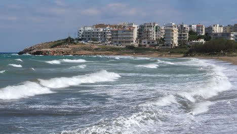 Apartment-buildings-along-the-Mediterranean-coast,-waves-hitting-beach