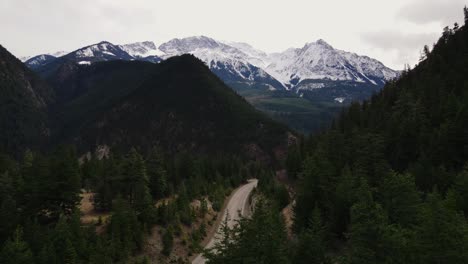 Aerial-drone-shot-of-road-near-Lake-Lillooet-in-British-Columbia-with-Mount-Brew-in-the-background