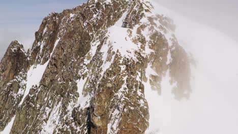 Cinematic-aerial-view-of-snow-capped-Cima-d'Asta-peak-in-Trentino