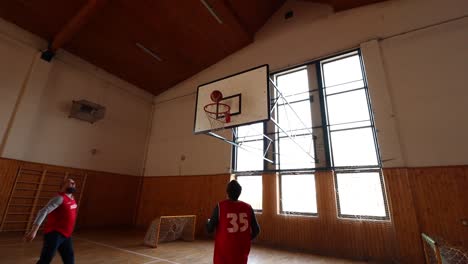 Two-Men-Doing-Basketball-Training-During-Covid-19,-One-Taking-a-Shot,-Dolly