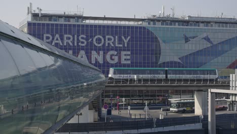 Modern-Orlyval-metro-at-Paris-Orly-airport-driving-past-reflective-glass-tunnel