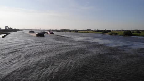 Aerial-View-Of-Veerhaven-Barge-Ship-Travelling-Moving-Along-Oude-Maas-In-Puttershoek