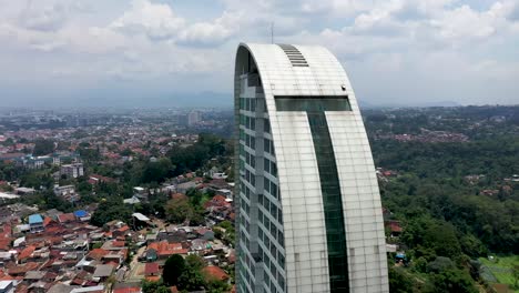 The-Maj-Meliá-Bandung-Dago-Spa-Hotel-buildings-in-the-downtown-area,-Aerial-orbit-around-close-up-shot